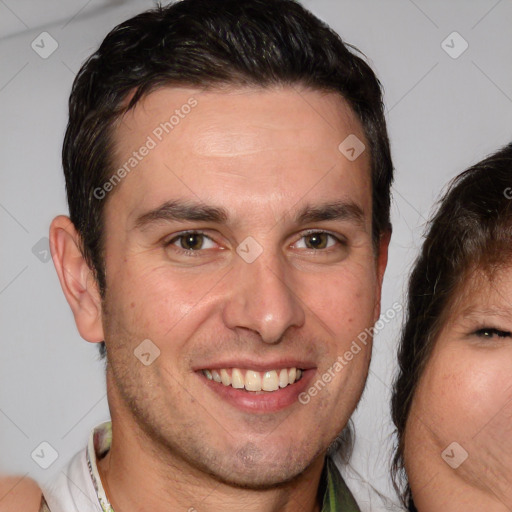 Joyful white adult male with short  brown hair and brown eyes