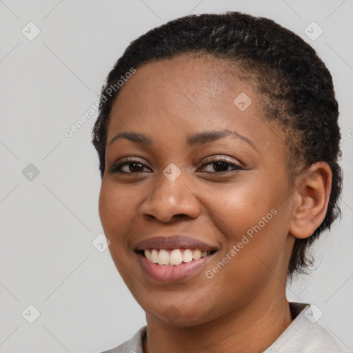 Joyful black young-adult female with short  brown hair and brown eyes