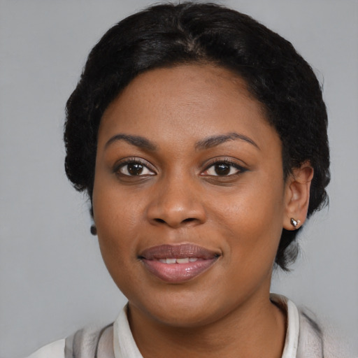 Joyful black young-adult female with medium  black hair and brown eyes