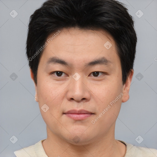 Joyful asian young-adult male with short  brown hair and brown eyes