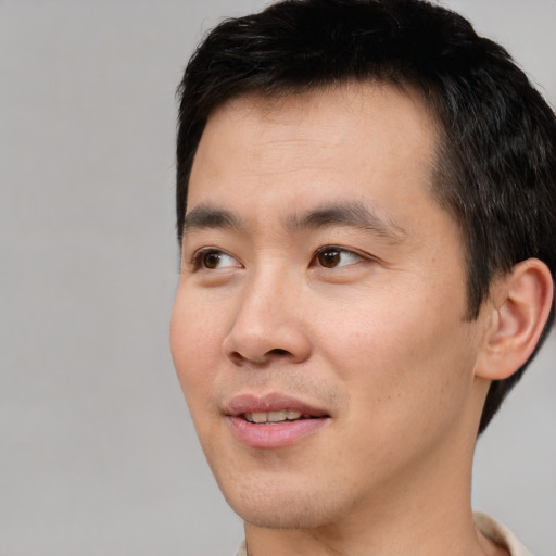 Joyful white young-adult male with short  black hair and brown eyes