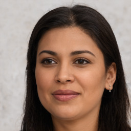 Joyful latino young-adult female with long  brown hair and brown eyes