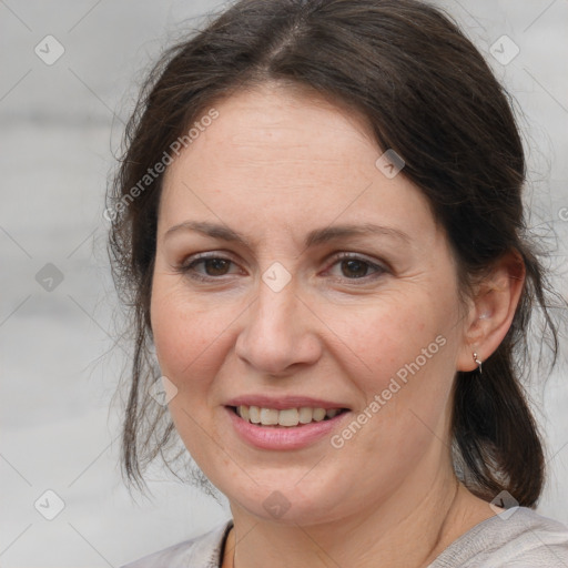 Joyful white adult female with medium  brown hair and brown eyes