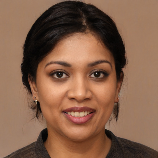 Joyful latino young-adult female with medium  black hair and brown eyes
