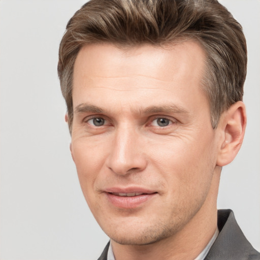 Joyful white adult male with short  brown hair and grey eyes