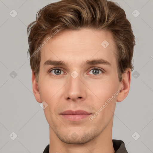 Joyful white young-adult male with short  brown hair and grey eyes