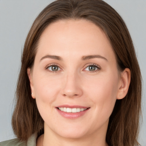 Joyful white young-adult female with long  brown hair and grey eyes