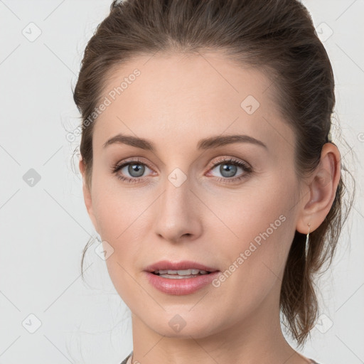 Joyful white young-adult female with medium  brown hair and grey eyes