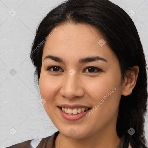 Joyful latino young-adult female with medium  brown hair and brown eyes