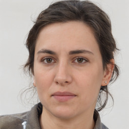 Joyful white adult female with medium  brown hair and brown eyes