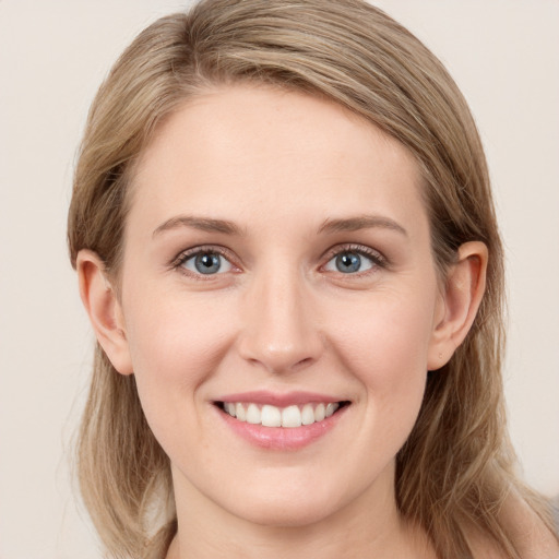 Joyful white young-adult female with long  brown hair and green eyes