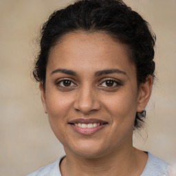 Joyful latino young-adult female with short  brown hair and brown eyes