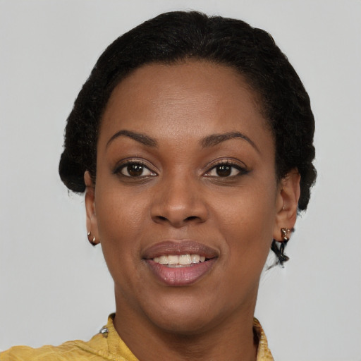 Joyful black young-adult female with short  brown hair and brown eyes
