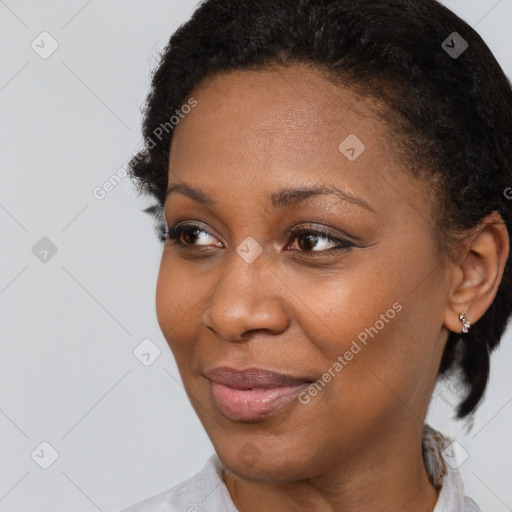 Joyful black adult female with short  brown hair and brown eyes