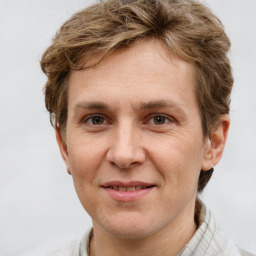 Joyful white adult male with short  brown hair and grey eyes