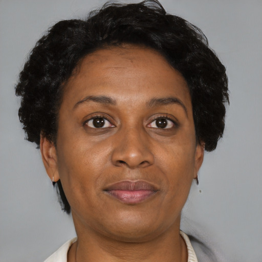 Joyful black adult female with short  brown hair and brown eyes
