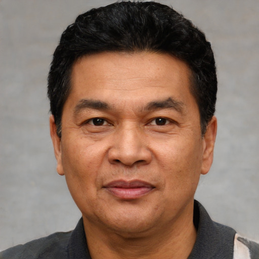 Joyful white adult male with short  black hair and brown eyes