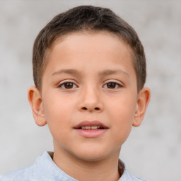 Joyful white child male with short  brown hair and brown eyes