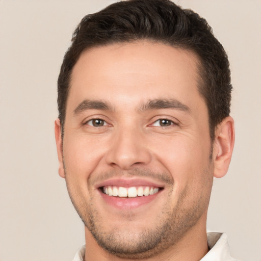 Joyful white young-adult male with short  brown hair and brown eyes