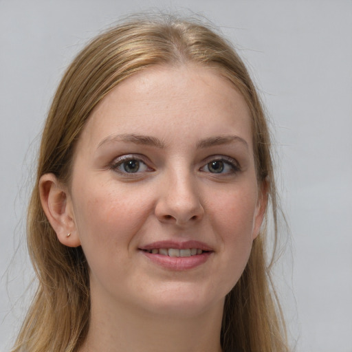 Joyful white young-adult female with long  brown hair and grey eyes