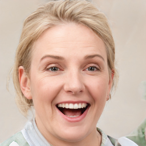 Joyful white young-adult female with medium  brown hair and blue eyes