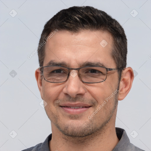 Joyful white adult male with short  brown hair and brown eyes