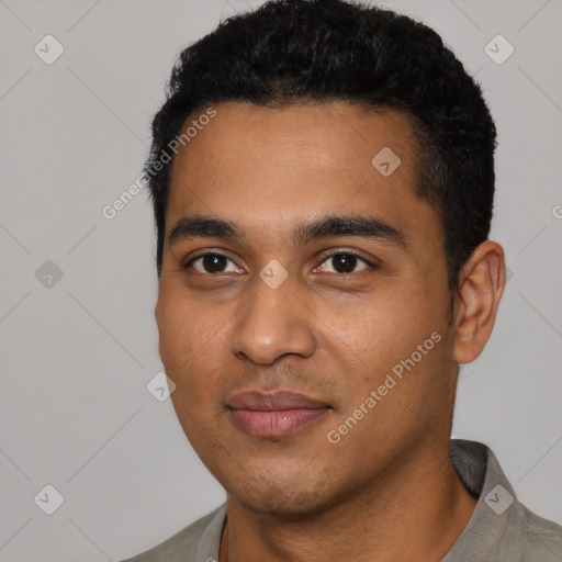 Joyful latino young-adult male with short  black hair and brown eyes