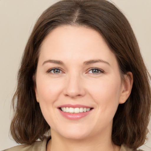 Joyful white young-adult female with medium  brown hair and brown eyes