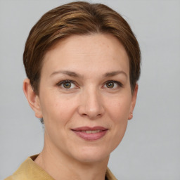 Joyful white young-adult female with short  brown hair and grey eyes