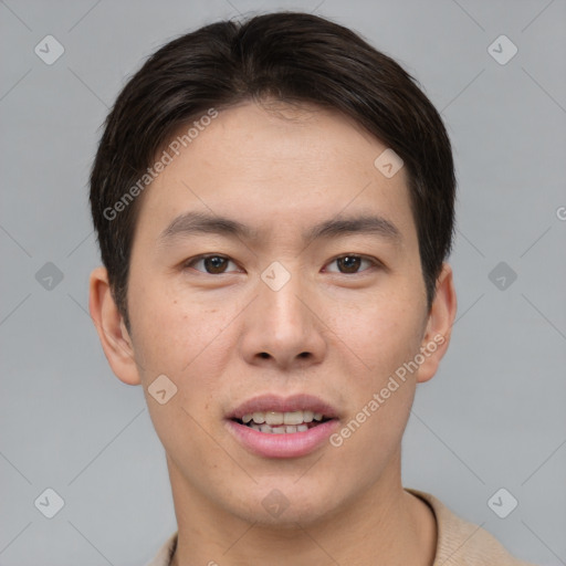 Joyful asian young-adult male with short  brown hair and brown eyes