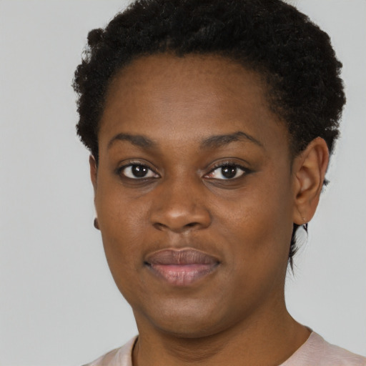 Joyful black young-adult female with short  brown hair and brown eyes