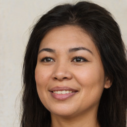 Joyful asian young-adult female with long  brown hair and brown eyes