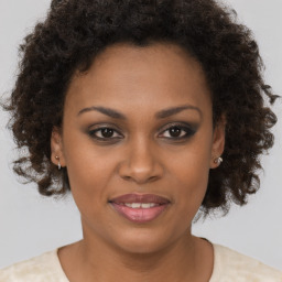 Joyful black young-adult female with short  brown hair and brown eyes