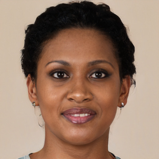 Joyful black young-adult female with short  brown hair and brown eyes