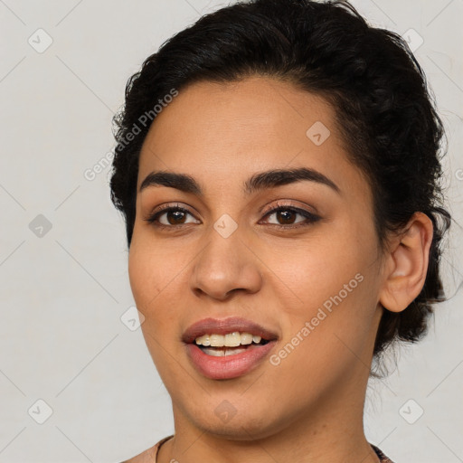 Joyful latino young-adult female with medium  brown hair and brown eyes