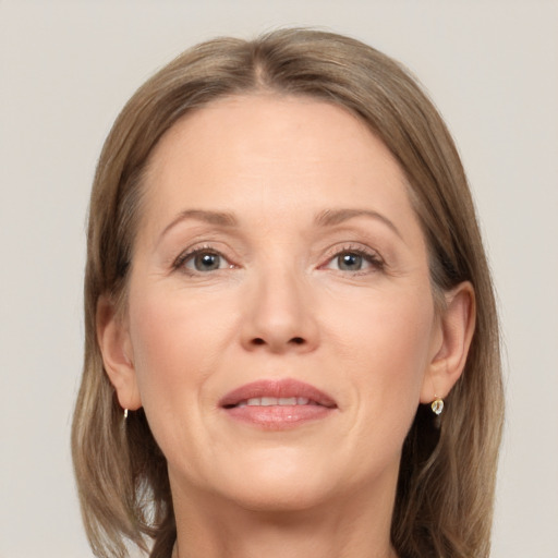 Joyful white adult female with medium  brown hair and grey eyes