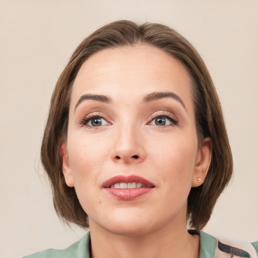 Joyful white young-adult female with medium  brown hair and grey eyes