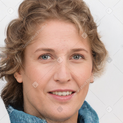 Joyful white adult female with short  brown hair and blue eyes