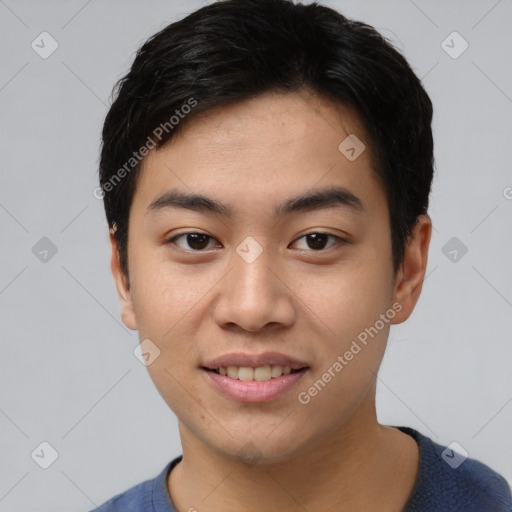 Joyful asian young-adult male with short  black hair and brown eyes