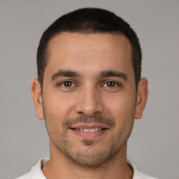 Joyful white young-adult male with short  brown hair and brown eyes