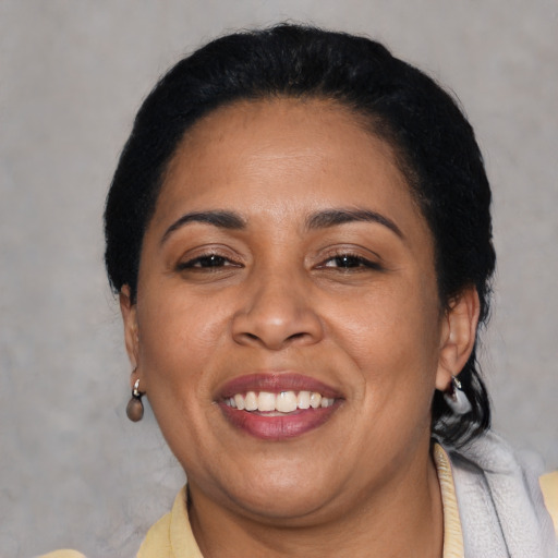 Joyful latino adult female with short  black hair and brown eyes