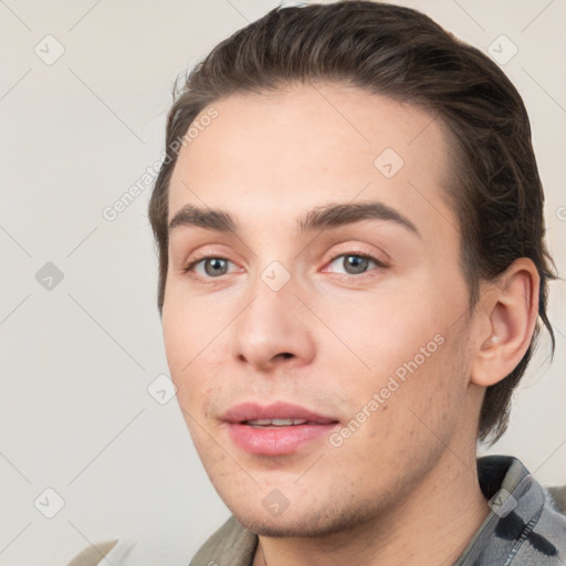 Joyful white young-adult male with short  brown hair and grey eyes