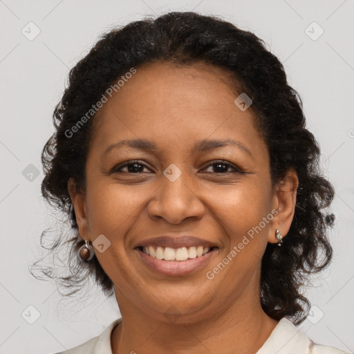 Joyful black adult female with medium  brown hair and brown eyes