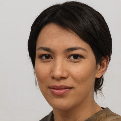Joyful asian young-adult female with medium  black hair and brown eyes