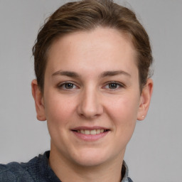 Joyful white young-adult female with short  brown hair and grey eyes