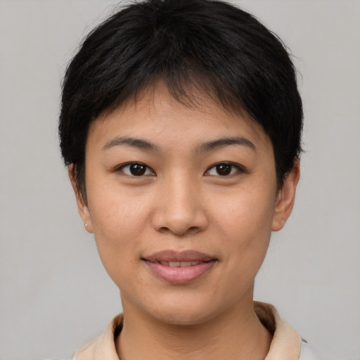 Joyful asian young-adult female with short  brown hair and brown eyes