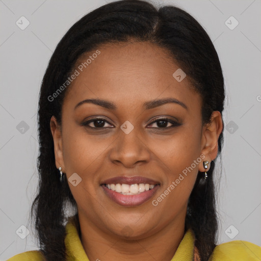 Joyful black young-adult female with long  brown hair and brown eyes