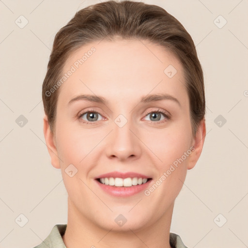 Joyful white young-adult female with short  brown hair and grey eyes