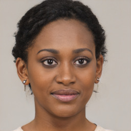 Joyful black young-adult female with short  brown hair and brown eyes