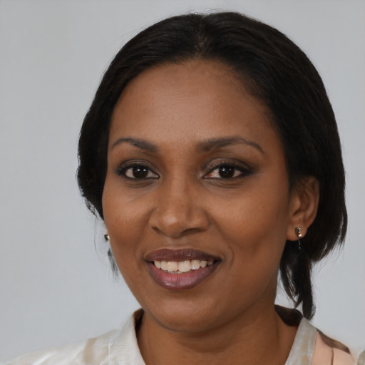 Joyful black adult female with medium  black hair and brown eyes